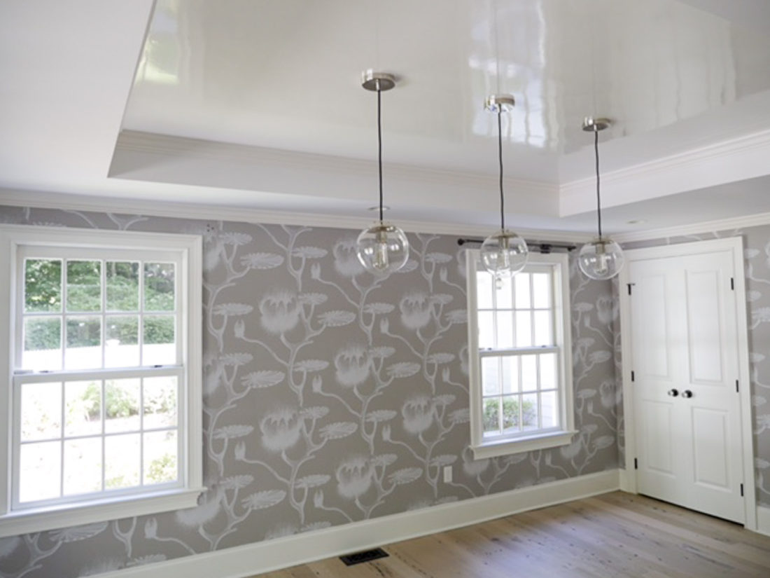 Eva Amurri Martino of the REZTT blog's dining room with grey and white patterned wallpaper, industrial globe lighting and high gloss white ceiling