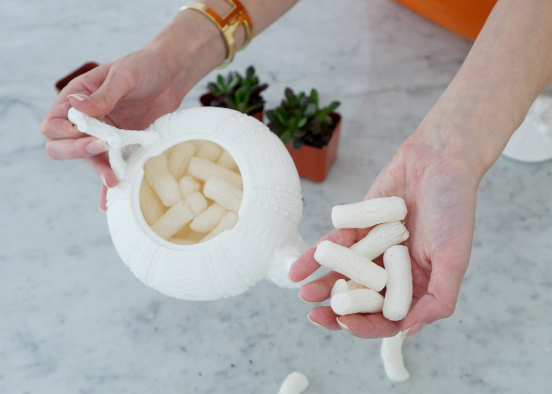 Eva Amurri Martino wearing a gold bracelet watch, showing how to craft DIY Teacup Planters on the REZTT blog using a pebbled porcelain tea pot and mini succulents