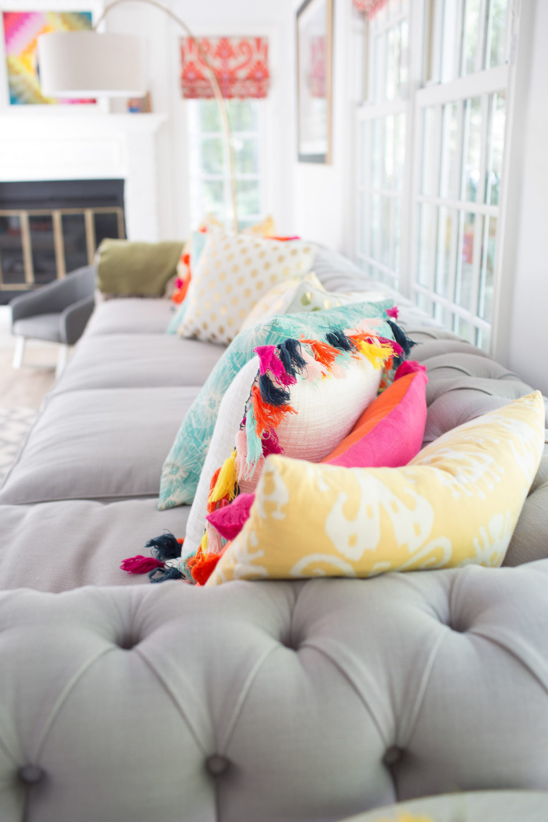 multicolored pillows on a grey couch in the family room of Eva Amurri Martino of lifestyle blog REZTT