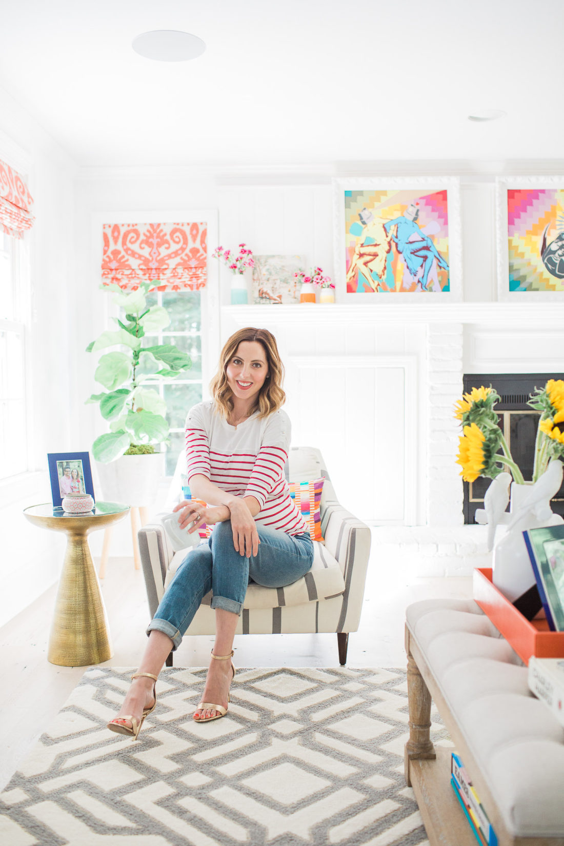 Eva Amurri Martino of Lifestyle Blog REZTT sitting in a striped armchair in the corner of her family room in connecticut