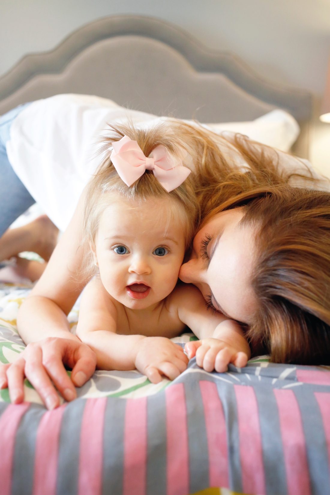 Eva Amurri Martino of REZTT blog snuggling with her daughter Marlowe who wears her hair in a pink bow