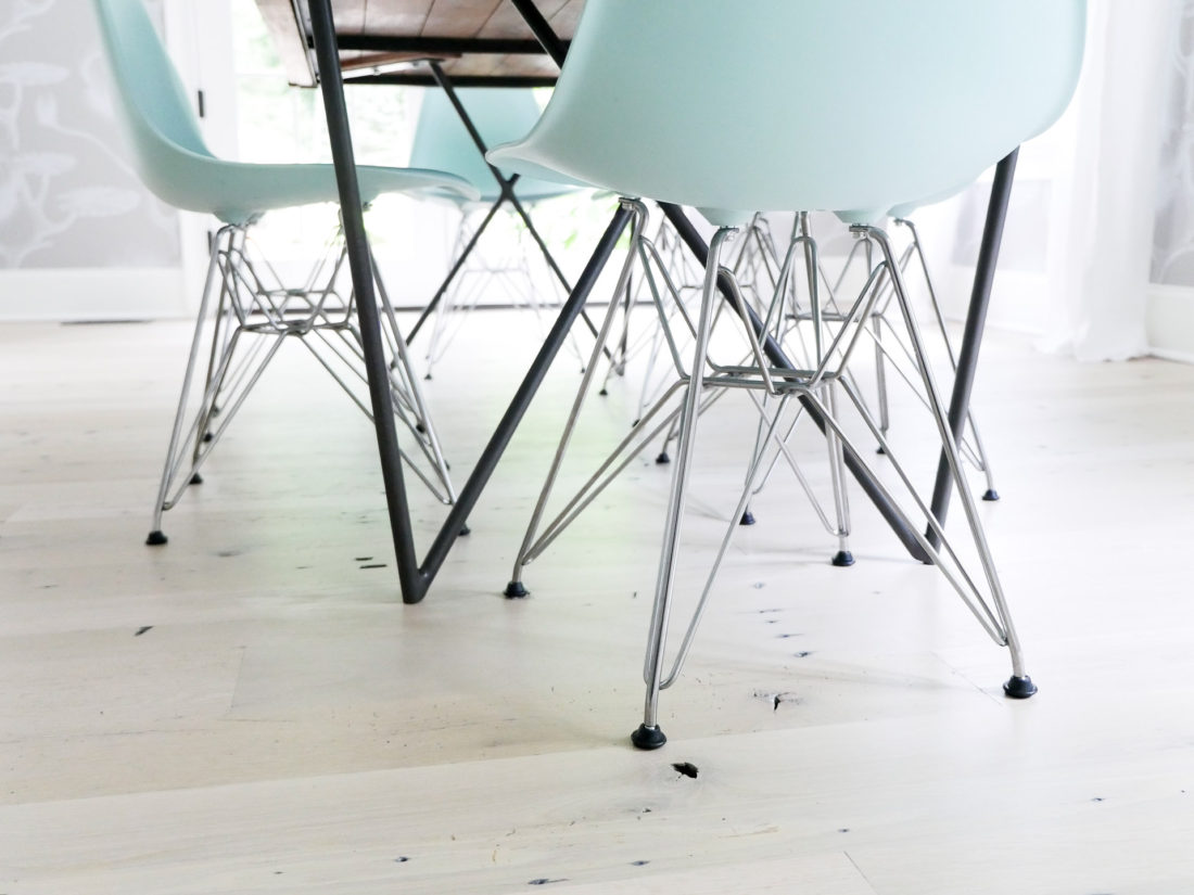 A detail shot of the robin's egg blue mid century modern eames molded chairs with an eiffel tower base featured in the dining room of REZTT's Eva Amurri Martino