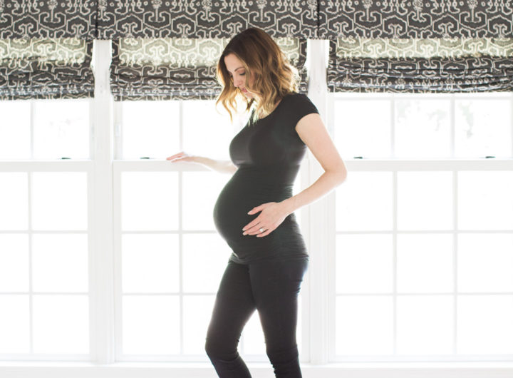 Eva Amurri Martino of lifestyle and motherhood blog REZTT, wearing all black and cradling her baby bump