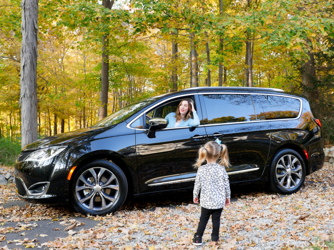 Eva Amurri Martino of lifestyle and motherhood blog REZTT drives her black Chrysler pacifica on the road in Connecticut while two year old daughter Marlowe looks on
