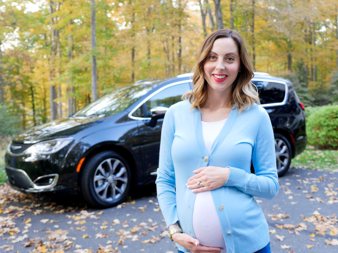 Eva Amurri Martino of lifestyle and motherhood blog REZTT pictured at nine months pregnant wearing a white Tshirt and blue Tory Burch cardigan