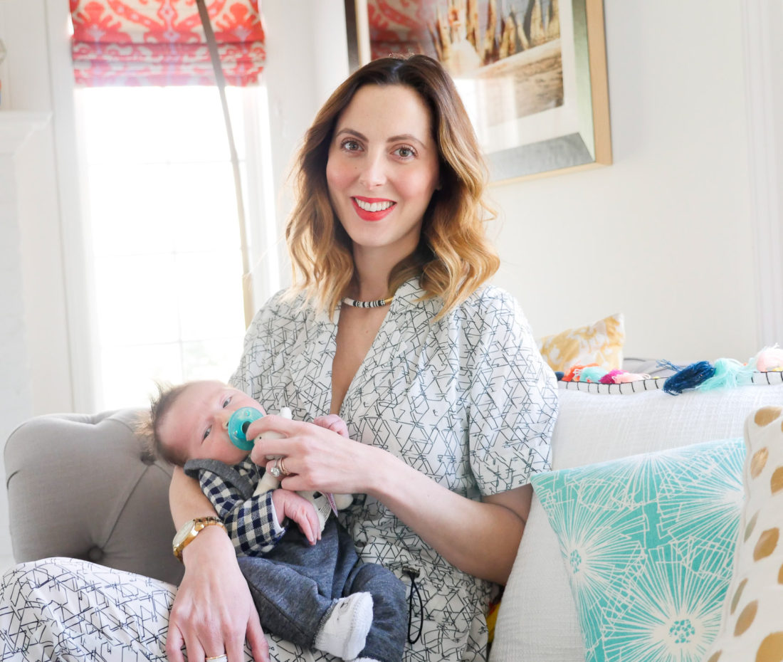Eva amurri Martino of lifestyle and motherhood blog REZTT, holding newborn son Major James at his Sip And See at home in Connecticut