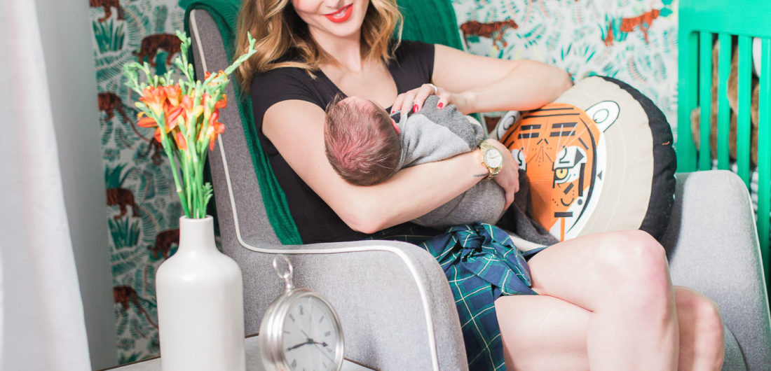 Eva Amurri Martino of lifestyle and motherhood blog REZTT holds her newborn son Major in his newly designed nursery in her connecticut home