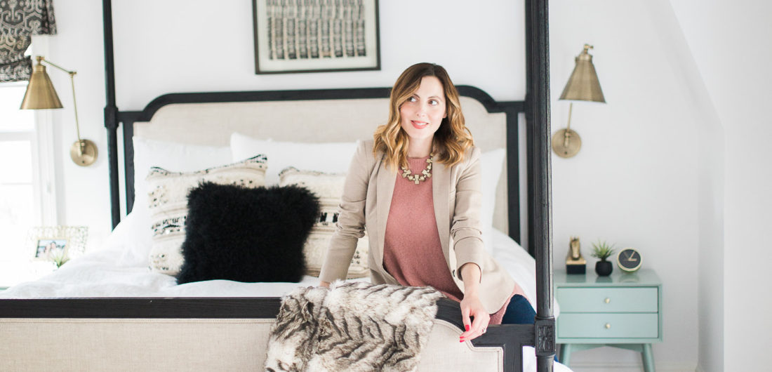 Eva Amurri Martino of lifestyle and motherhood blog REZTT poses in her black, white, and brass master bedroom in Connecticut