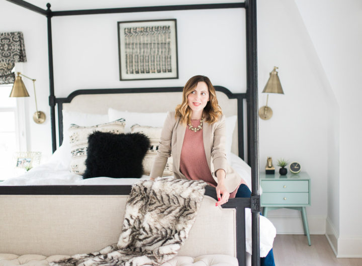 Eva Amurri Martino of lifestyle and motherhood blog REZTT poses in her black, white, and brass master bedroom in Connecticut