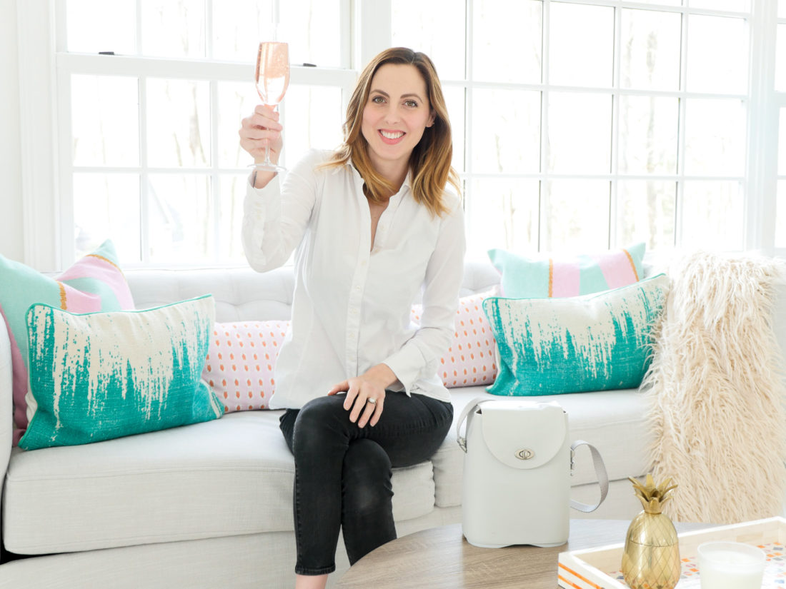 Eva Amurri Martino of lifestyle and motherhood blog REZTT pictured in her studio with a glass of sparkling rose