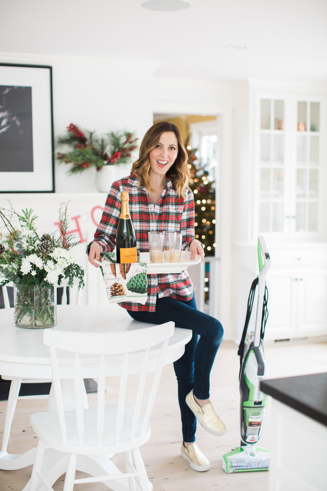 Eva Amurri Martino prepares for a holiday party in her kitchen with a tray of drinks and the bissell crosswave cleaning system