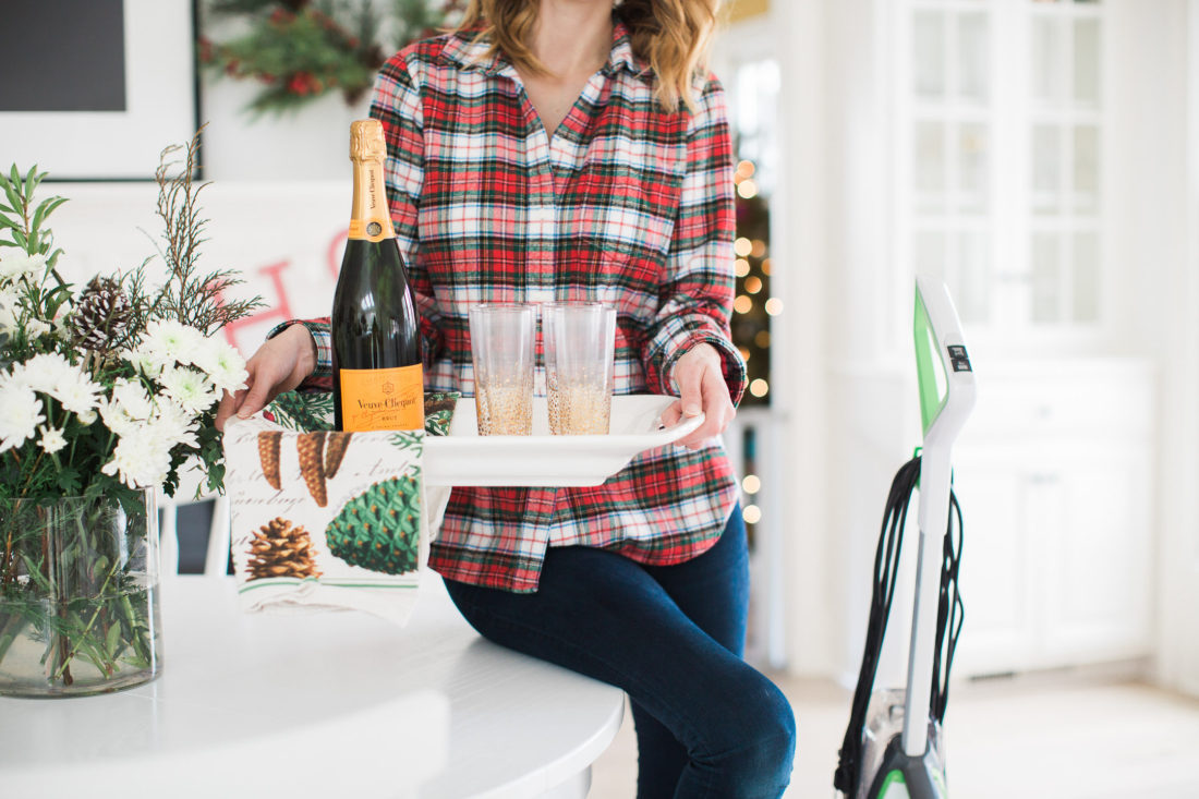 Eva Amurri Martino of lifestyle and motherhood blog REZTT holds a tray of cocktails as she prepares her home for a Holiday party