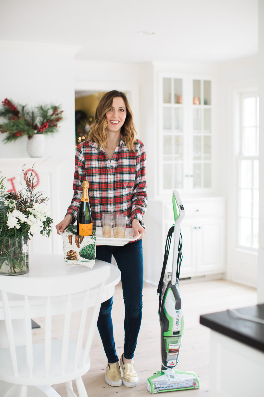 Eva Amurri Martino of lifestyle and motherhood blog REZTT holds a tray of cocktails as she prepares her home for a Holiday party