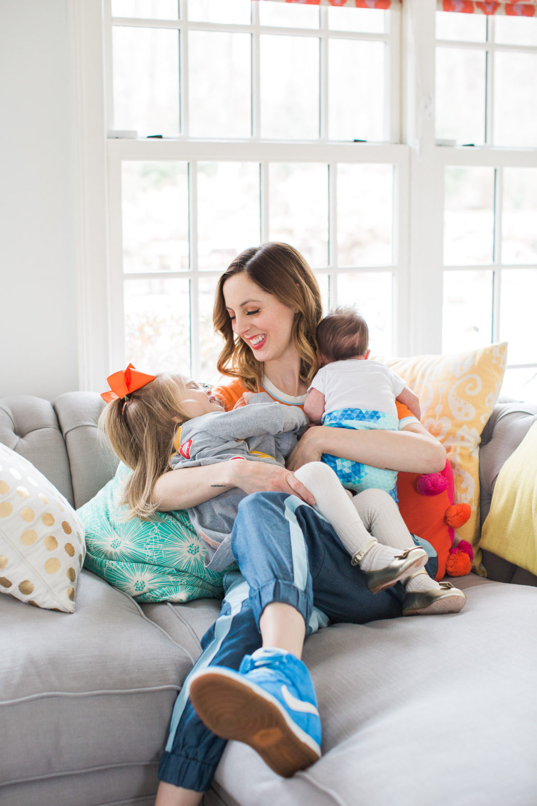 Eva Amurri Martino of lifestyle and motherhood blog REZTT, embraces her two year old daughter Marlowe and her newborn son Major in their family home in connecticut