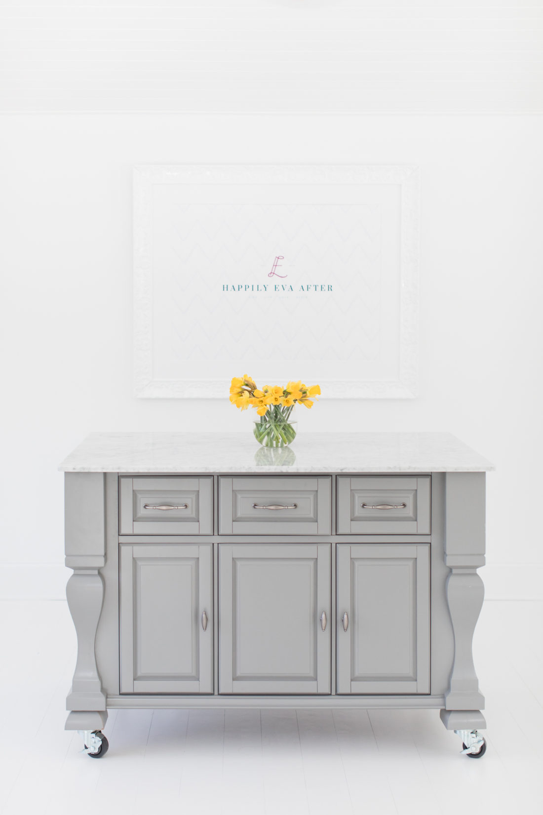 The marble topped island and framed logo in the REZTT studio