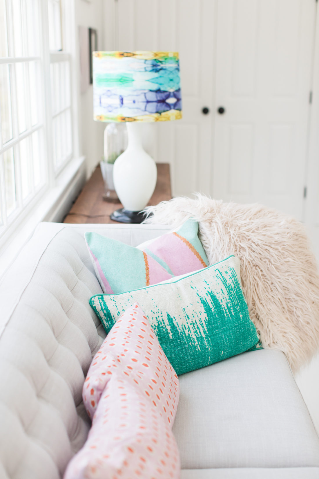 an array of pillows on the couch in the REZTT sitting area