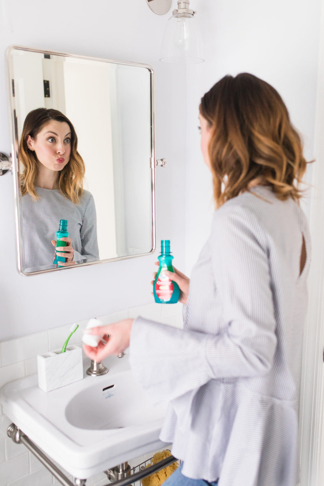 Eva Amurri Martino swishes mouthwash in her mouth before spitting