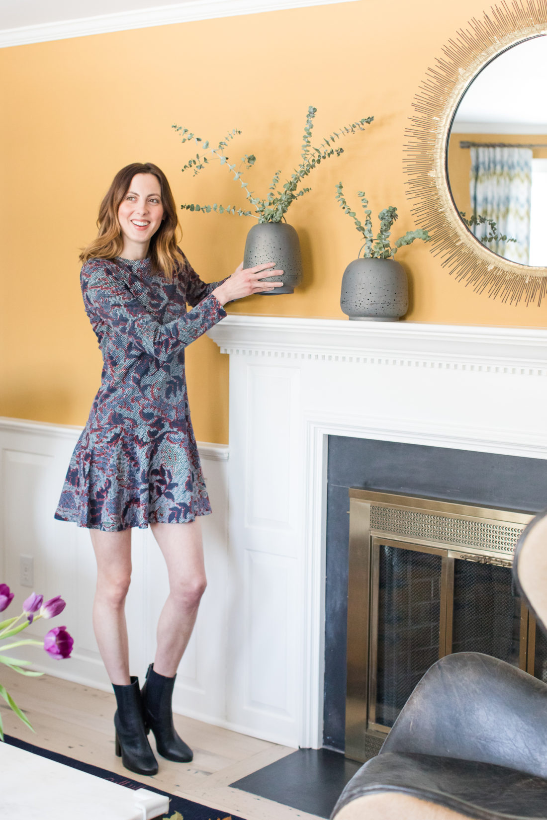 Eva Amurri Martino of lifestyle and motherhood blog REZTT sets some decor on the mantle in the formal living room of her Connecticut home