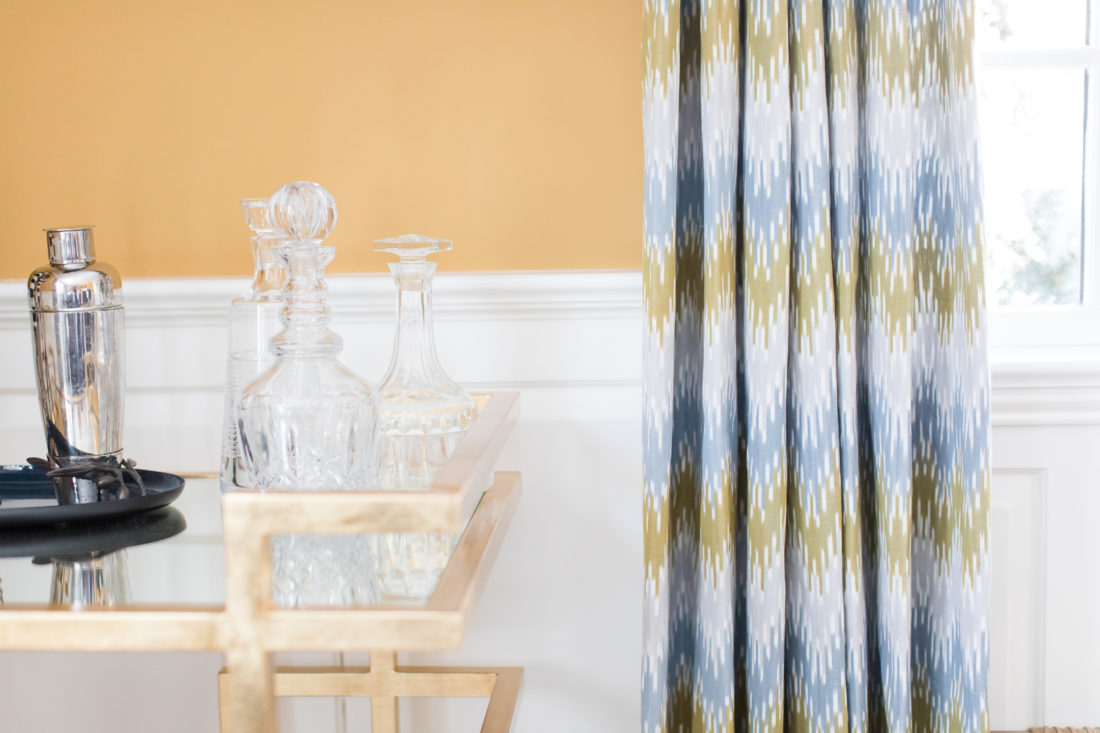 Crystal liquor decanters on the gilded bar cart in Eva Amurri Martino's formal living room