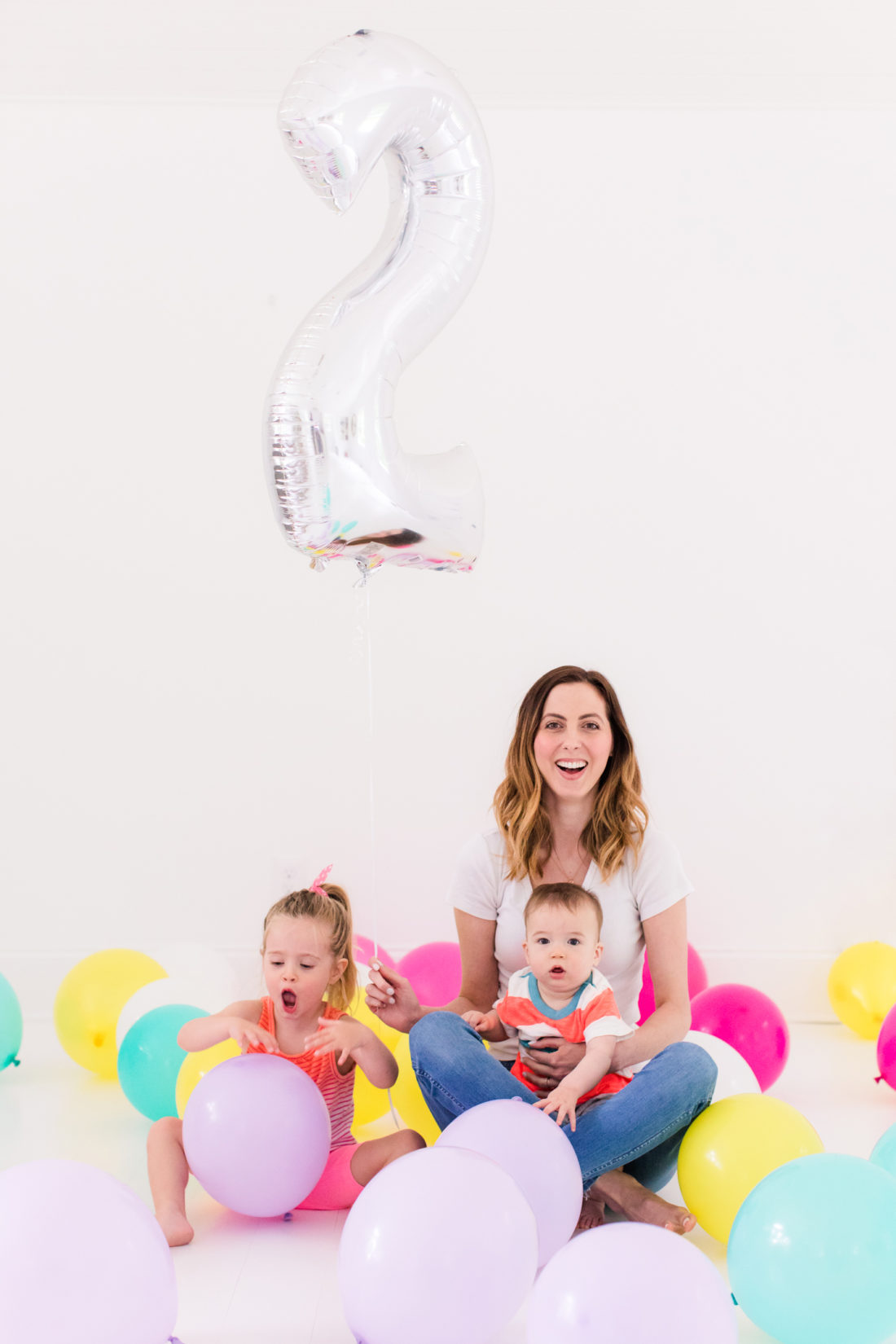 Eva Amurri Martino sits with children Marlowe and Major among tons of multicolored balloons to celebrate the REZTT two year anniversary
