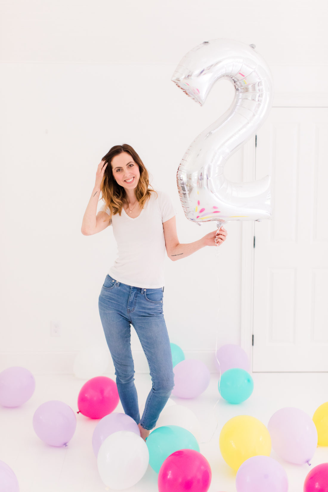Eva Amurri Martino stands in the REZTT studio filled with balloons to celebrate the second anniversary of the blog