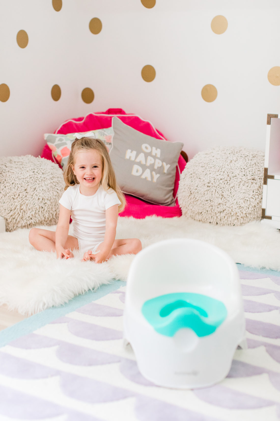 Marlowe Martino sits in her room with her potty chair