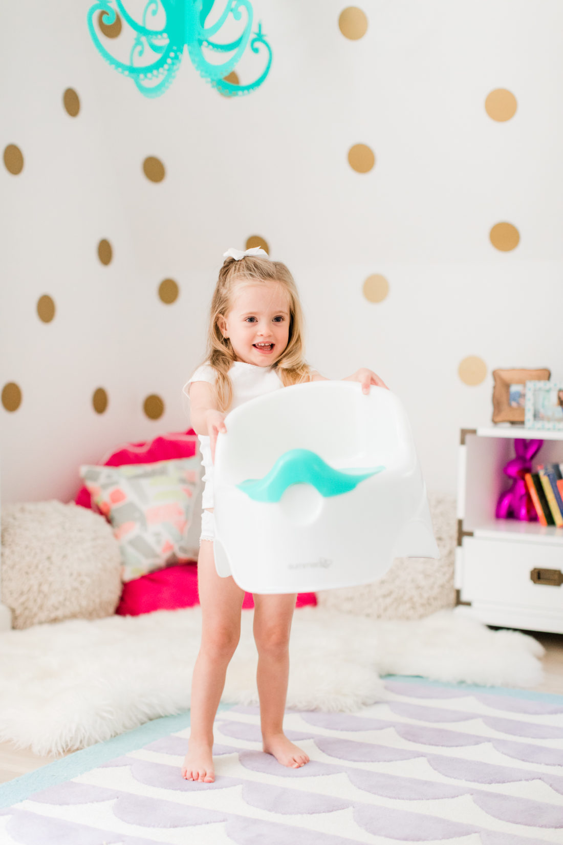 Marlowe Martino shows off her potty chair in her bedroom