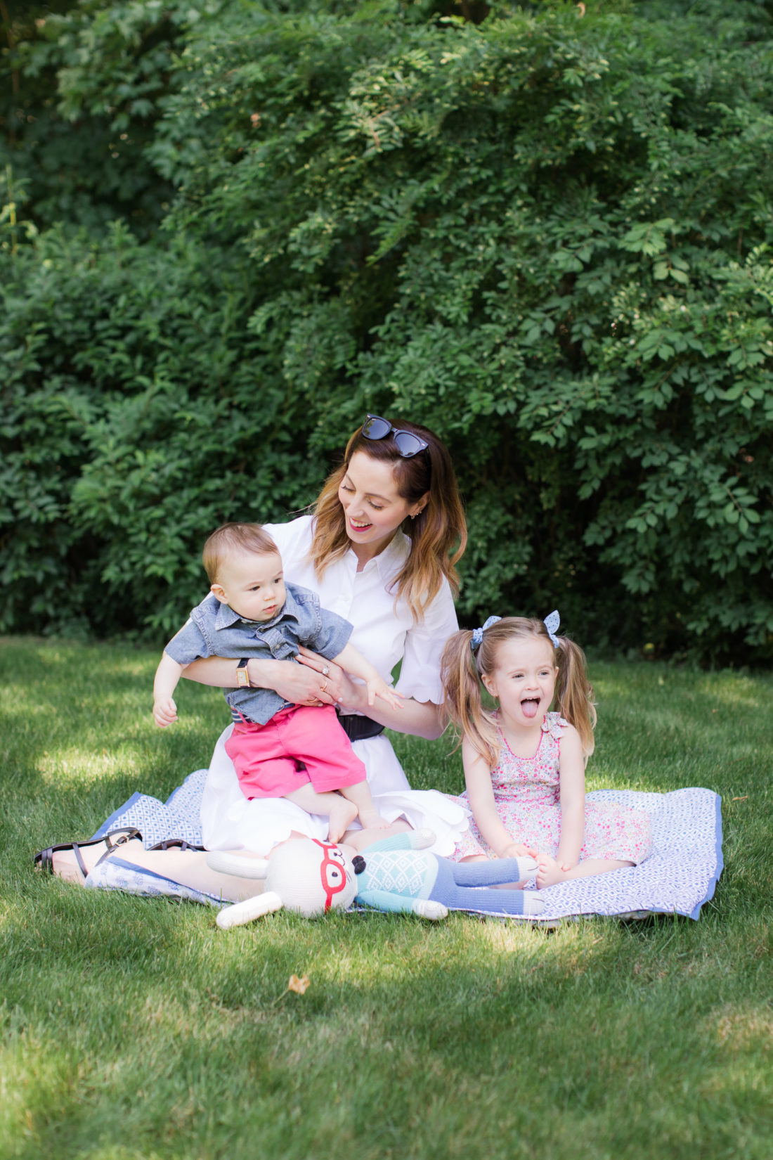 Eva Amurri Martino of lifestyle and motherhood blog REZTT relaxes on a picnic blanket with her two children Marlowe and Major