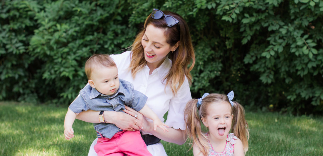 Eva Amurri Martino of lifestyle and motherhood blog REZTT relaxes on a picnic blanket with her two children Marlowe and Major