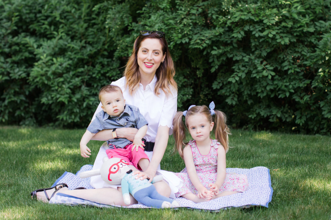 Eva Amurri Martino of lifestyle and motherhood blog REZTT relaxes on a picnic blanket with her two children Marlowe and Major