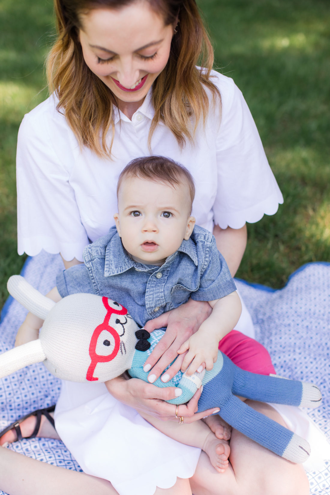 Eva Amurri Martino of lifestyle and motherhood blog REZTT relaxes on a picnic blanket with her two children Marlowe and Major