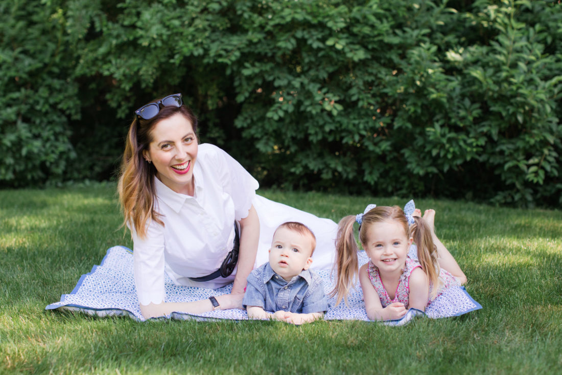 Eva Amurri Martino of lifestyle and motherhood blog REZTT relaxes on a picnic blanket with her two children Marlowe and Major