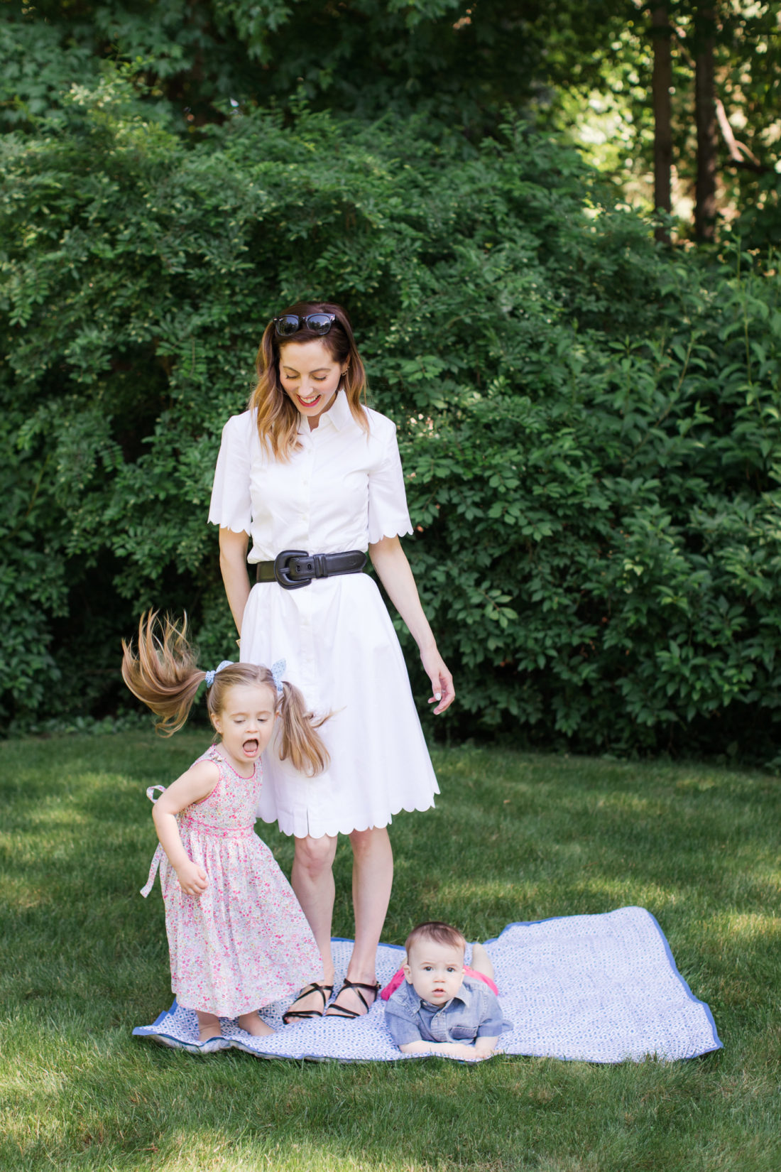 Eva Amurri Martino of lifestyle and motherhood blog REZTT relaxes on a picnic blanket with her two children Marlowe and Major