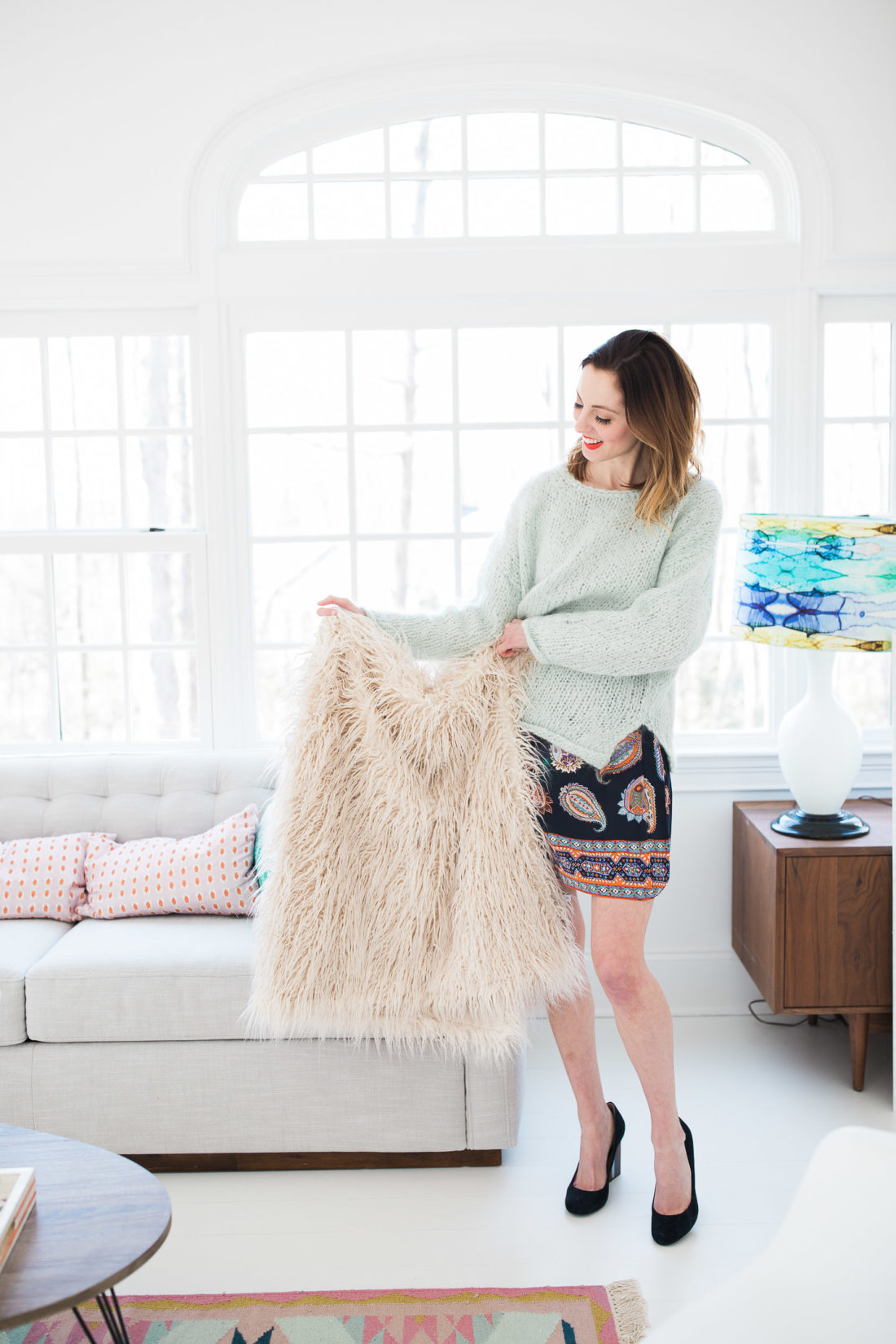 Eva Amurri Martino holds up a fuzzy shag throw blanket in her studio