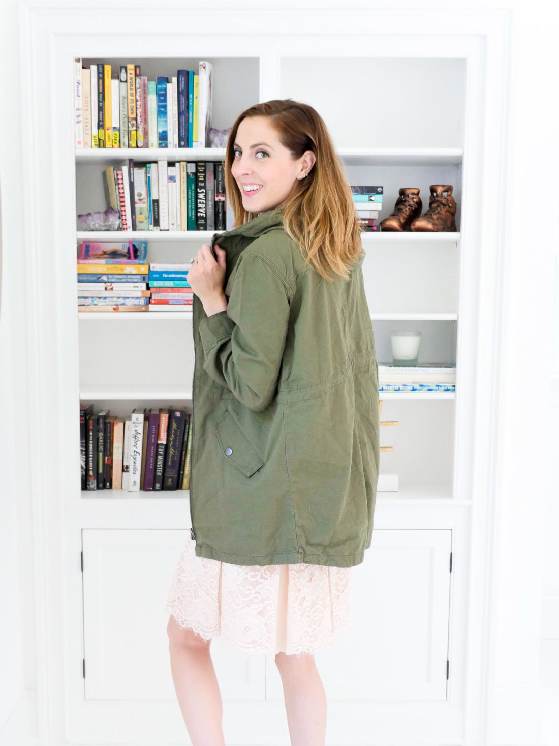 Eva Amurri Martino wears an olive green hooded anorak jacket over a black tank top