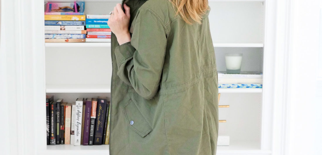 Eva Amurri Martino wears an olive green hooded anorak jacket over a black tank top