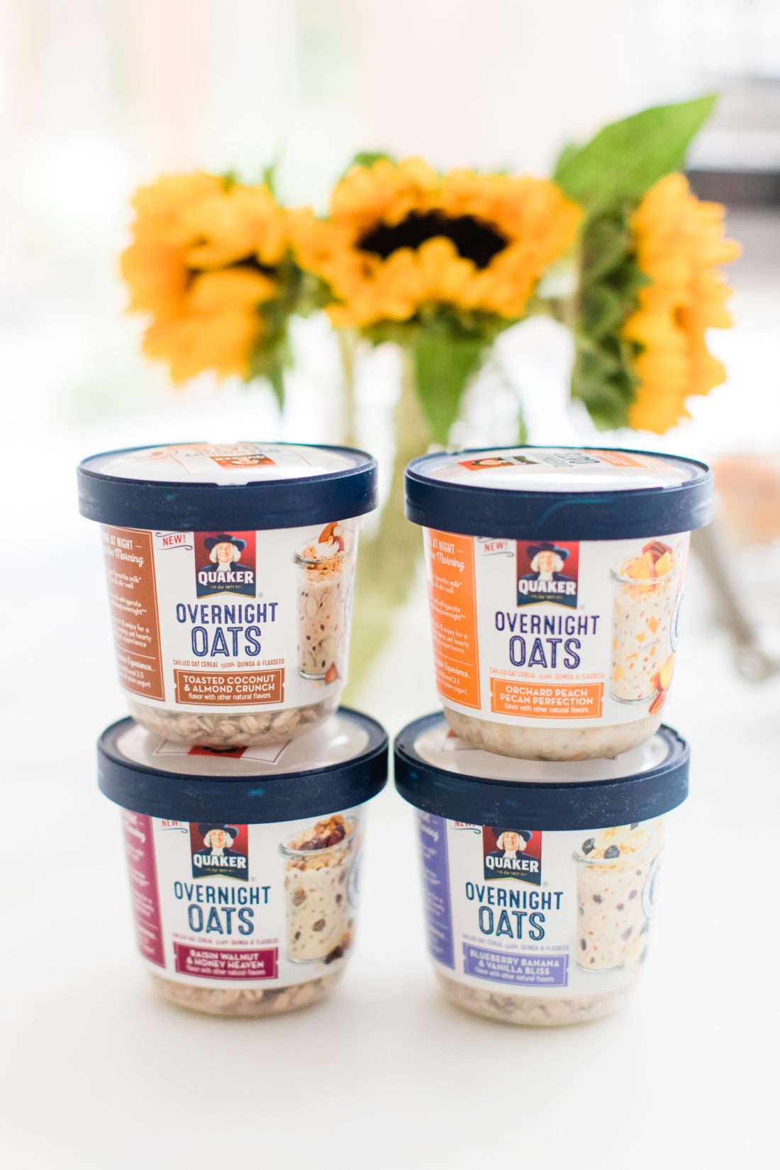 Eva Amurri Martino stacks up containers of Quaker Overnight Oats on the marble countertop of her Connecticut kitchen