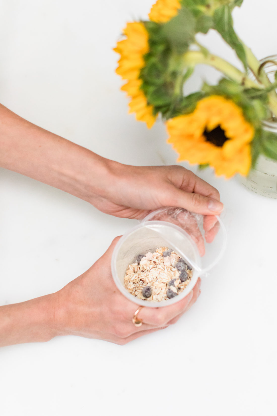 Eva Amurri Martino peels back the plastic top of a container of Quaker Overnight Oats