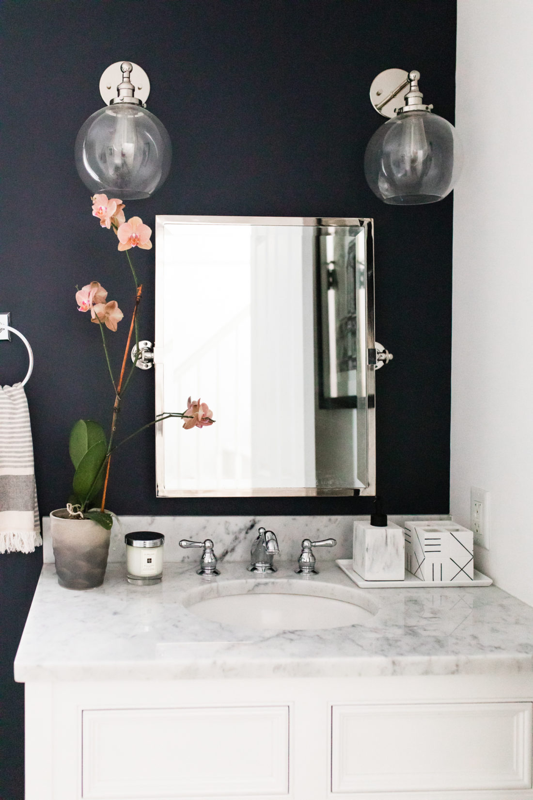 The wall sconces, vintage mirror, and marble vanity of Eva Amurri Martino's Connecticut powder room