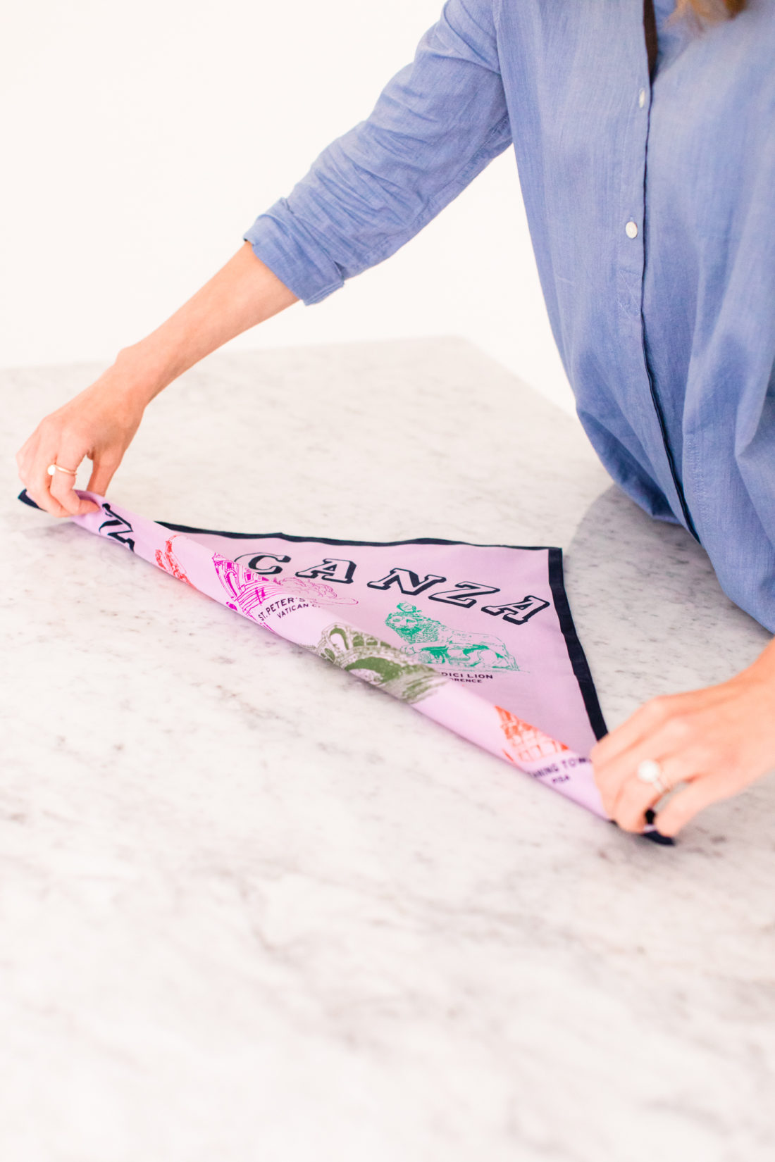 Eva Amurri Martino folds a square silk scarf to tie in to a kerchief choker