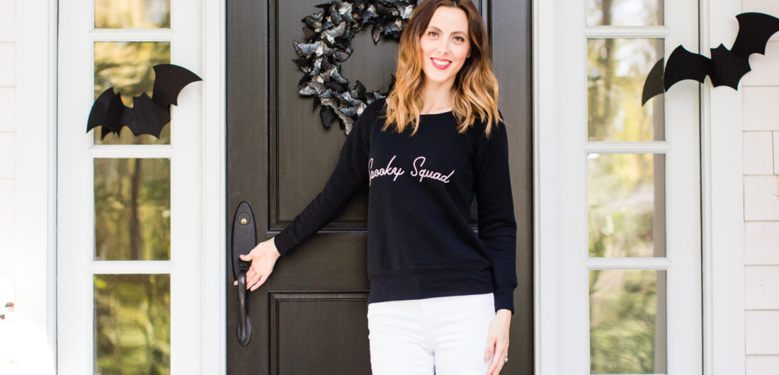 Eva Amurri Martino stands at the entryway to her Connecticut home that is decorated with a spooky bat theme for Halloween