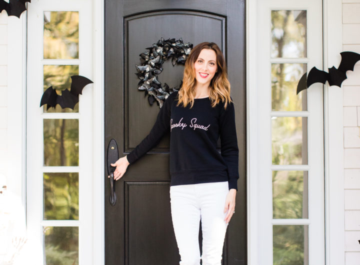 Eva Amurri Martino stands at the entryway to her Connecticut home that is decorated with a spooky bat theme for Halloween