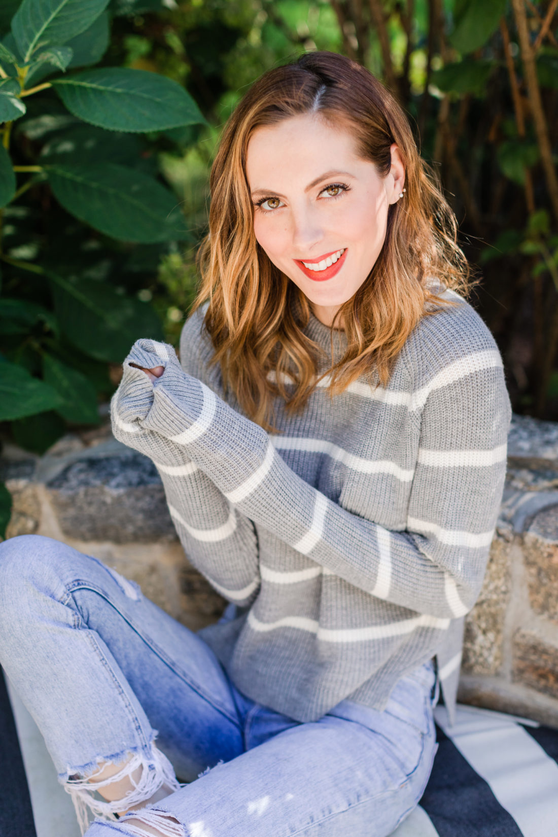Eva Amurri Martino wears a striped sweater and red heels out by her fire pit in Connecticut