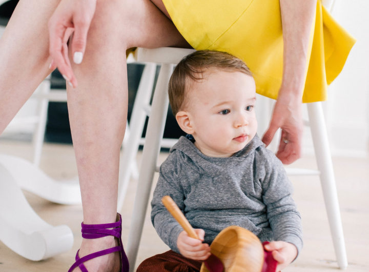 Major Martino sits on the kitchen floor next to his Mom's chair and plays with a SpoonfulOne feeding bowl