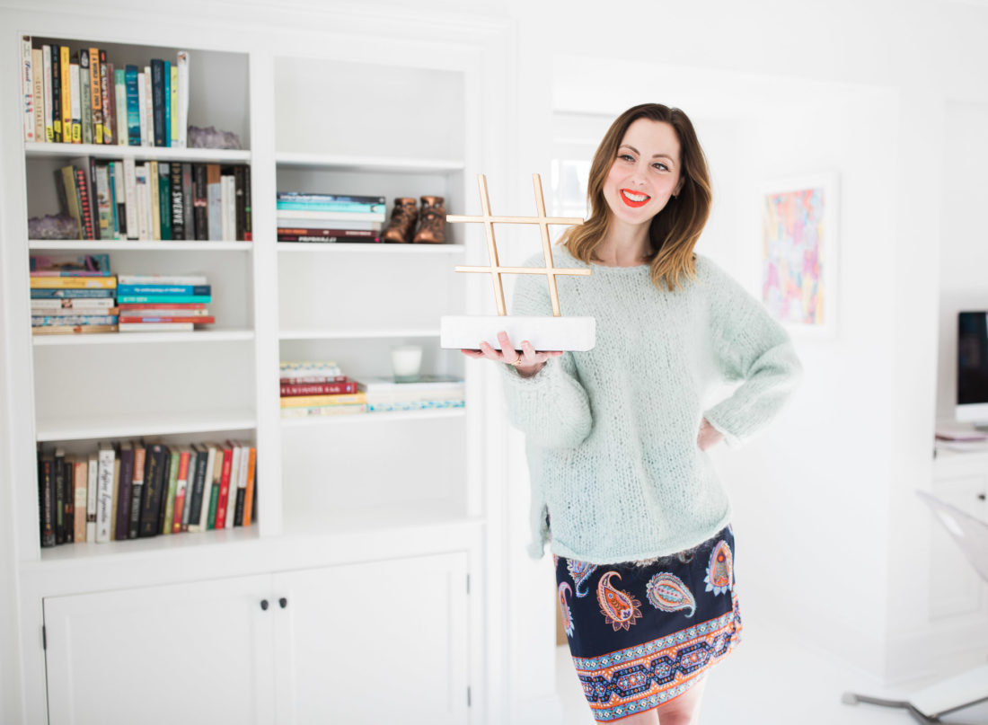 Eva Amurri Martino holds a marble and brass hashtag object in the studio of her Connecticut home