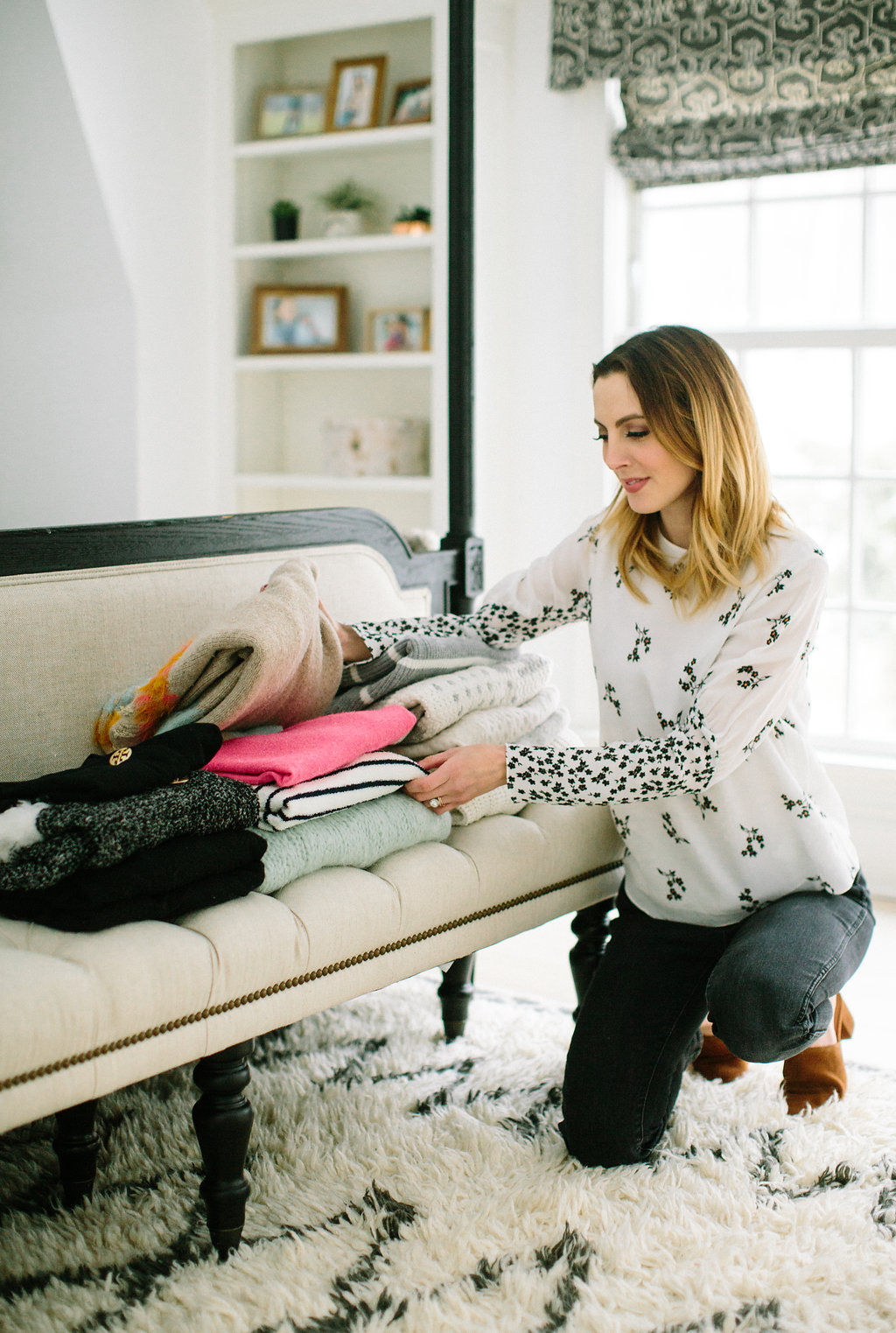 Eva Amurri Martino makes stacks of sweaters on the bed at the foot of her master bed