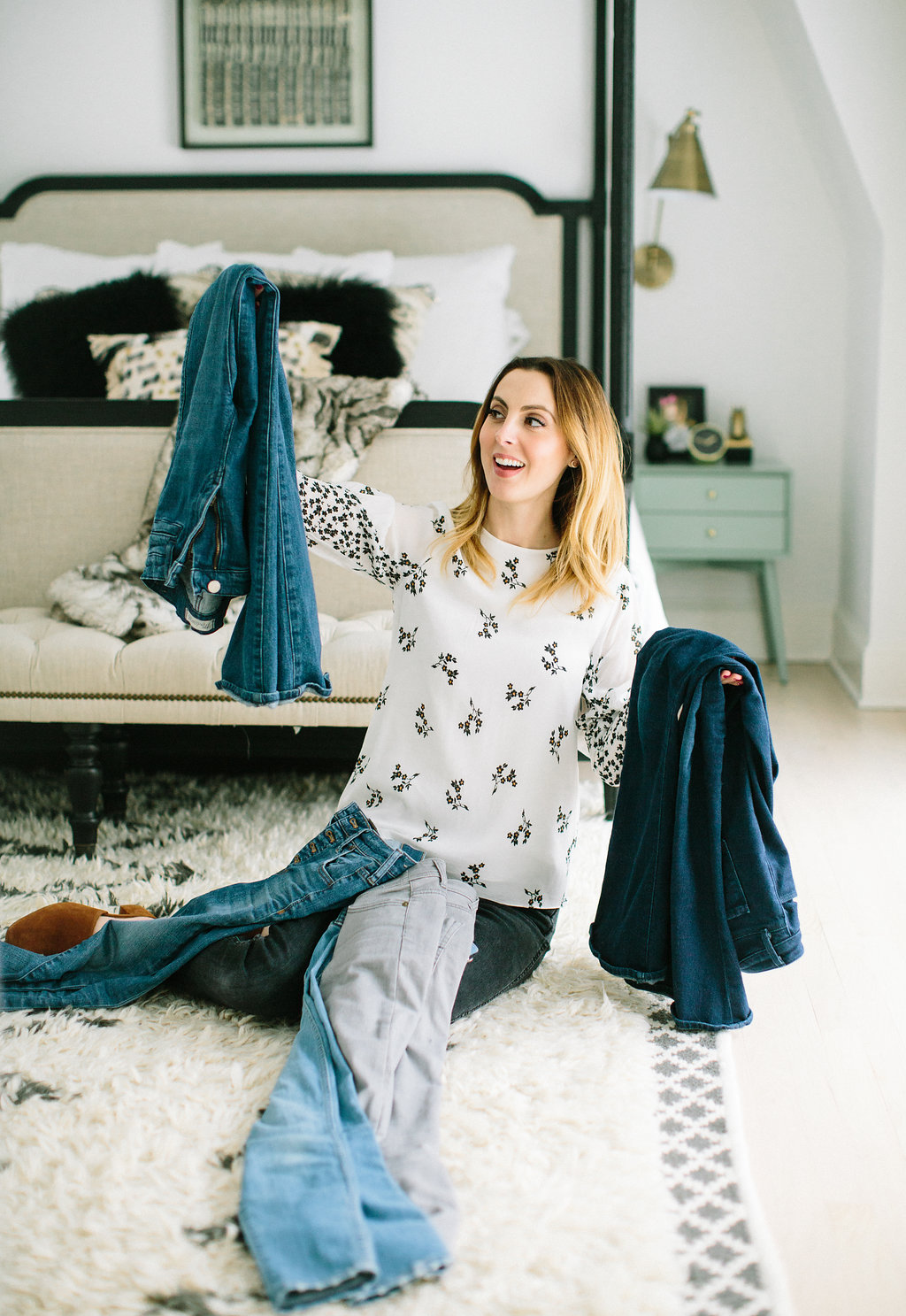 Eva Amurri Martino sits with a pile of jeans on her lap as she cleans out her closet