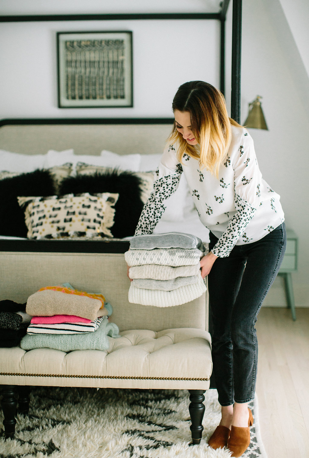 Eva Amurri Martino makes stacks of sweaters on the bed at the foot of her master bed