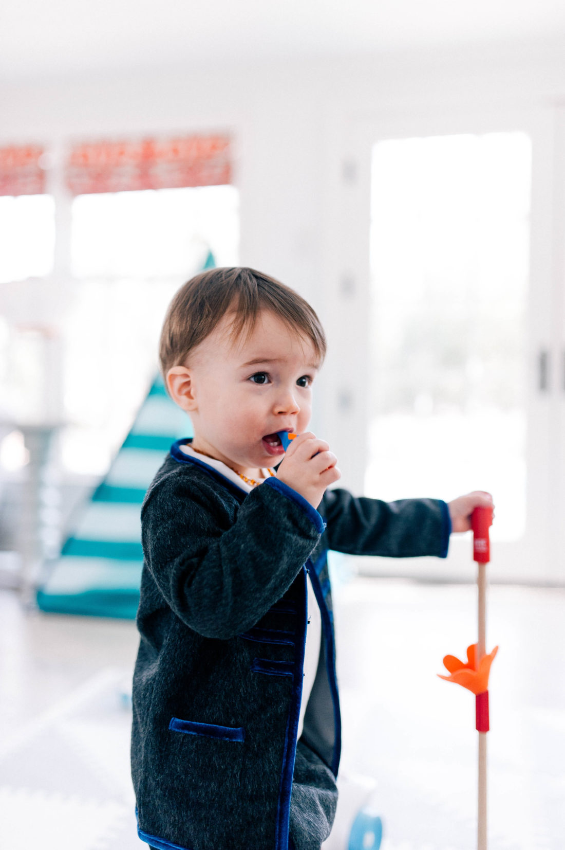 Major Martino wears a grey mohair suit and brushes his few teeth with a baby tooth brush in the family room of his Connecticut home