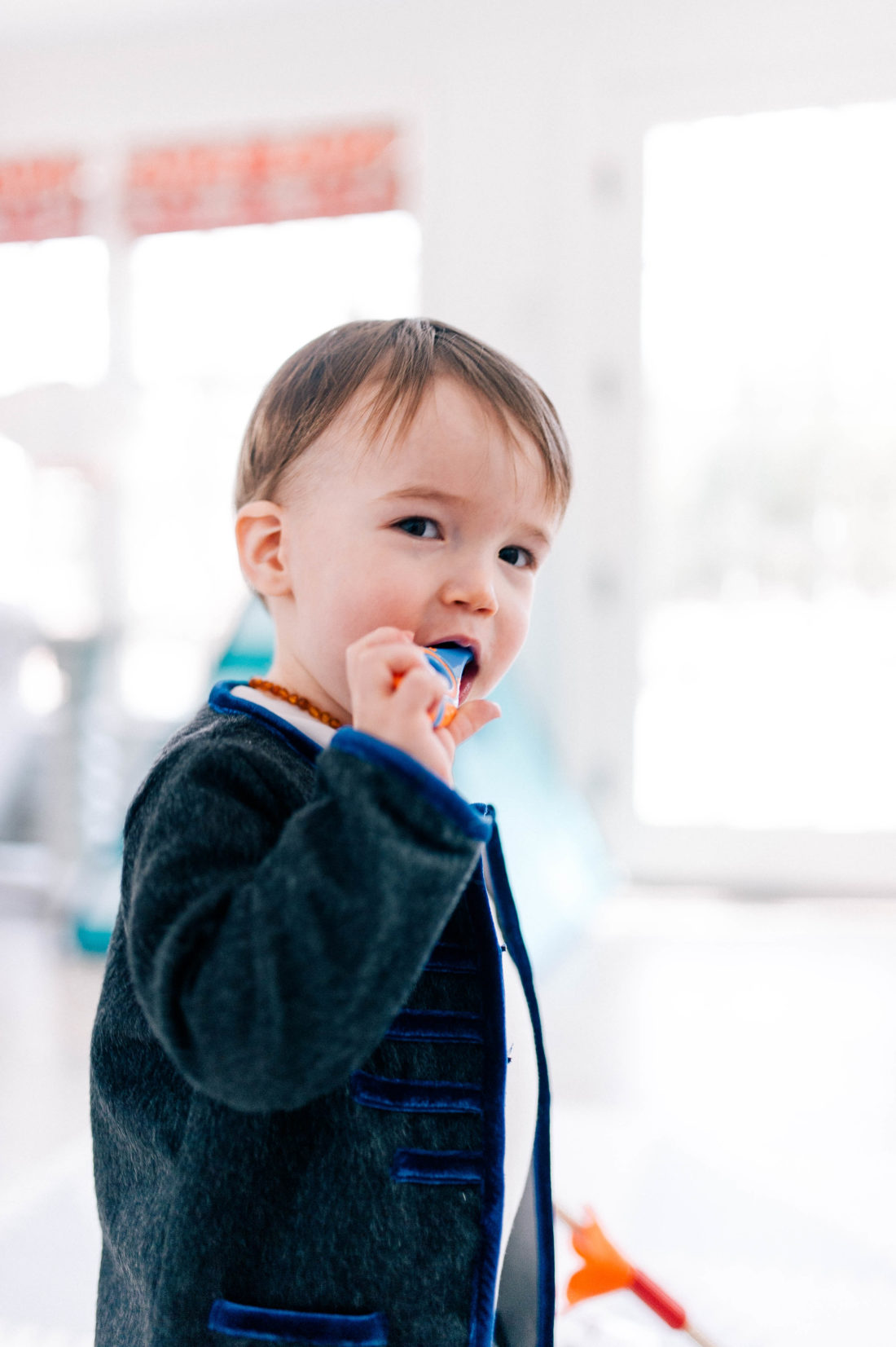 Major Martino wears a grey mohair suit and brushes his few teeth with a baby tooth brush in the family room of his Connecticut home